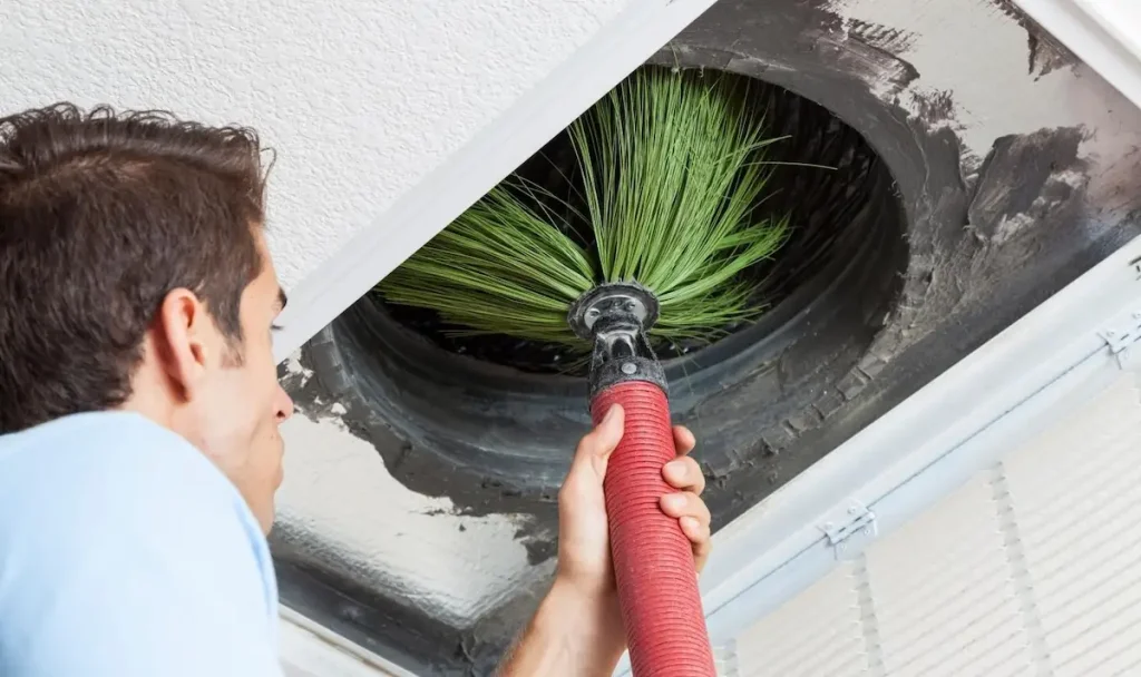 Cleaning an air duct with brush